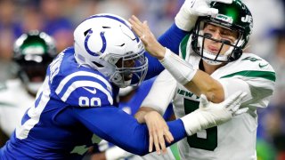 Indianapolis Colts defensive tackle DeForest Buckner (99) puts pressure on New York Jets quarterback Mike White.