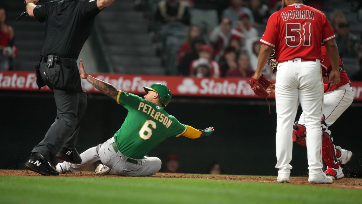 Athletics score three runs in extra innings to win wild game vs. Angels
