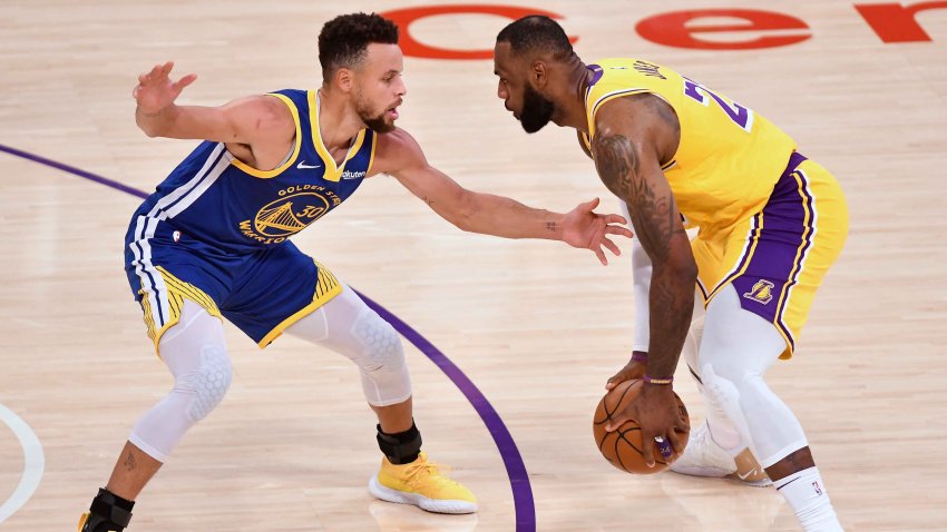 Jan 18, 2021; Los Angeles, California, USA; Golden State Warriors guard Stephen Curry (30) defends Los Angeles Lakers forward LeBron James (23) during the second quarter at Staples Center. Mandatory Credit: Robert Hanashiro-USA TODAY Sports
