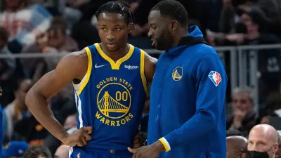 October 30, 2021; San Francisco, California, USA; Golden State Warriors forward Jonathan Kuminga (00) listens to forward Draymond Green (23) during the fourth quarter against the Oklahoma City Thunder at Chase Center. Mandatory Credit: Kyle Terada-USA TODAY Sports