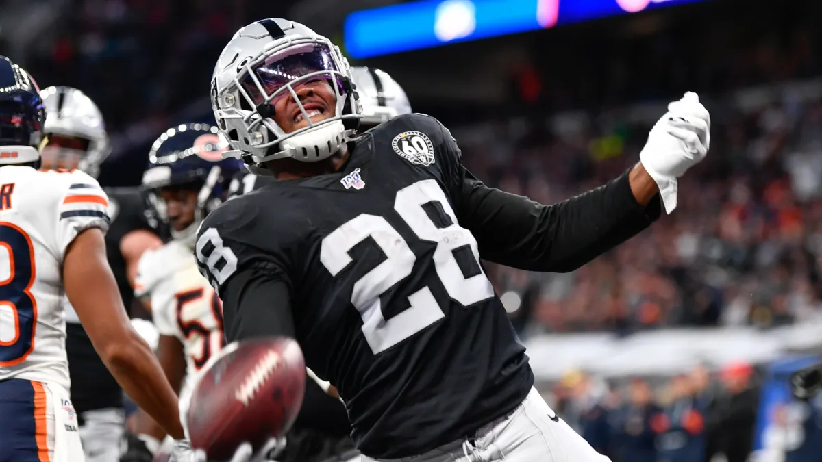 Raiders' Josh Jacobs runs over Packers' Adrian Amos