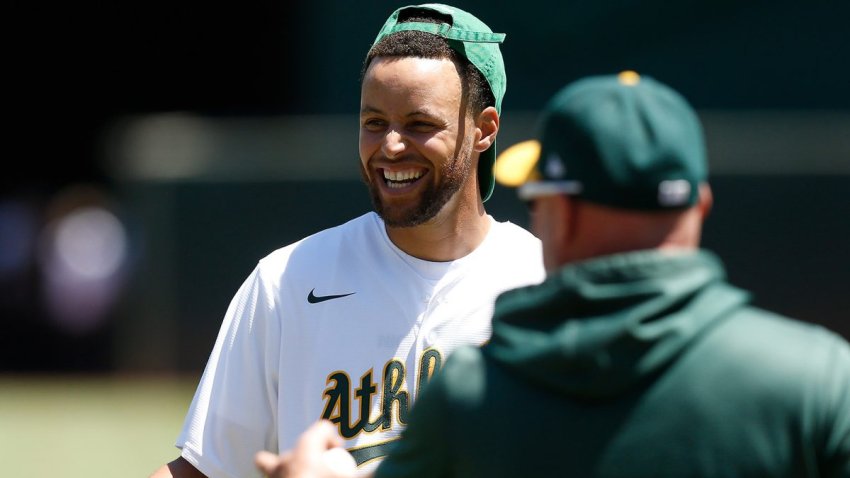 OAKLAND, CALIFORNIA – JULY 27: Stephen Curry of the Golden State Warriors NBA team laughs after he and his wife Ayesha Curry throw out the ceremonial first pitch before the game between the Oakland Athletics and the Houston Astros at RingCentral Coliseum on July 27, 2022 in Oakland, California. (Photo by Lachlan Cunningham/Getty Images)