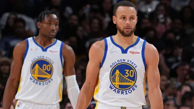 DENVER, CO – MARCH 10: Jonathan Kuminga #00 and Stephen Curry #30 of the Golden State Warriors look on during the game against the Denver Nuggets on March 10, 2022 at the Ball Arena in Denver, Colorado. NOTE TO USER: User expressly acknowledges and agrees that, by downloading and/or using this Photograph, user is consenting to the terms and conditions of the Getty Images License Agreement. Mandatory Copyright Notice: Copyright 2022 NBAE (Photo by Bart Young/NBAE via Getty Images)