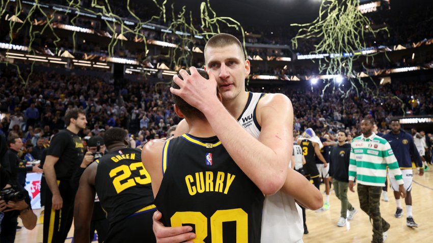 Steph Curry and Nikola Jokic embrace following the conclusion of the Warriors-Nuggets playoff series in 2022.