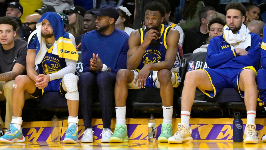 May 12, 2023; Los Angeles, California, USA;  Golden State Warriors guard Stephen Curry (30) Andre Iguodala (9), guard Ryan Rollins (2) and guard Klay Thompson (11) sit on from the bench in the final minutes of the second half of game six of the 2023 NBA playoffs against the Los Angeles Lakers at Crypto.com Arena. Mandatory Credit: Jayne Kamin-Oncea-USA TODAY Sports