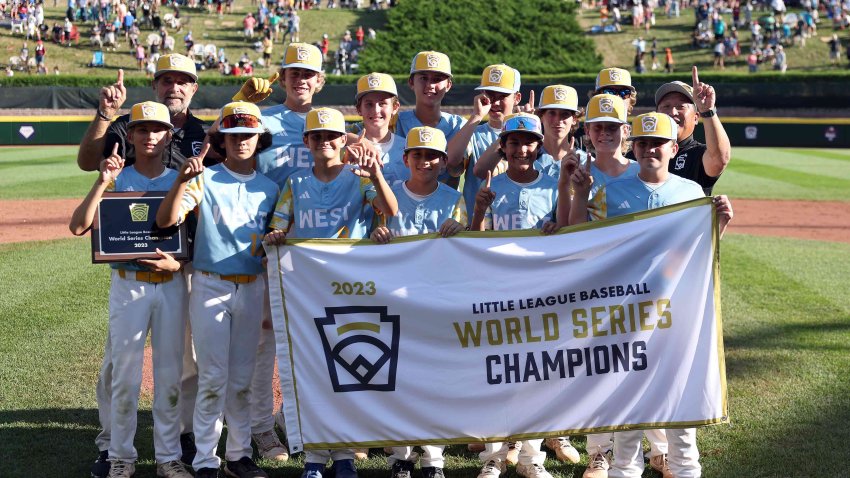 Members of the West Region team from El Segundo, Calif., pose with the championship banner after defeating of the Caribbean Region team from Willemstad, Curacao, to win the Little League World Series Championship Game at Little League International Complex on August 27, 2023 in South Williamsport, Pa.