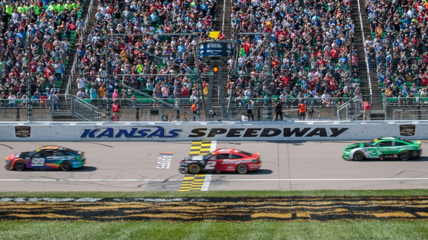 Cars cross the start finish to begin the NASCAR Cup Series Hollywood Casino 400 at the Kansas Speedway in Kansas City, Kan.