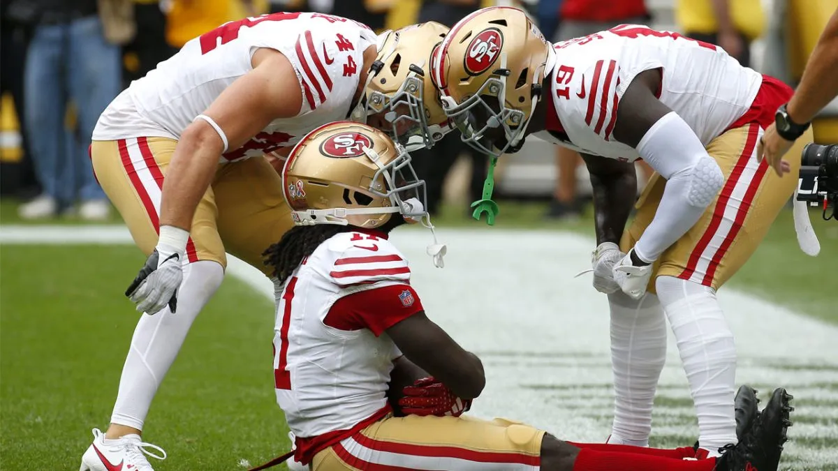 Santa Clara, California, USA. 18th Oct, 2020. San Francisco 49ers wide  receiver Brandon Aiyuk (11) celebrates touchdown with team member in front  of TV screen on Sunday, October 18, 2020, at Levis