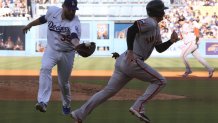 Giants beat Dodgers in extras, stave off elimination