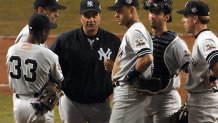 PHOENIX, UNITED STATES: New York Yankees Manager Joe Torre (3rd R) stands on the mound with the Yankees infield players during a pitching change in Game 6 of the World Series against the Arizona Diamondbacks in Phoenix 03 November 2001. AFP PHOTO/Mike NELSON (Photo credit should read MIKE NELSON/AFP via Getty Images)