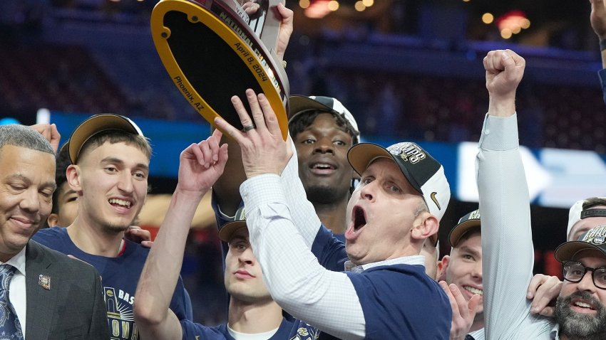 Dan Hurley holds a trophy