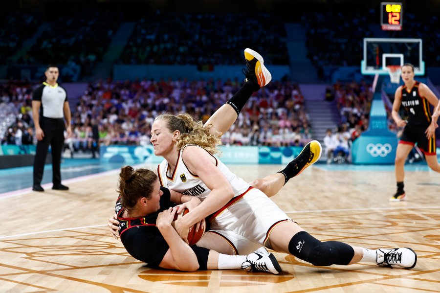 Belgium's Kyara Linskens (left) and Germany's Marie Guelich (right) fall while gripping the ball