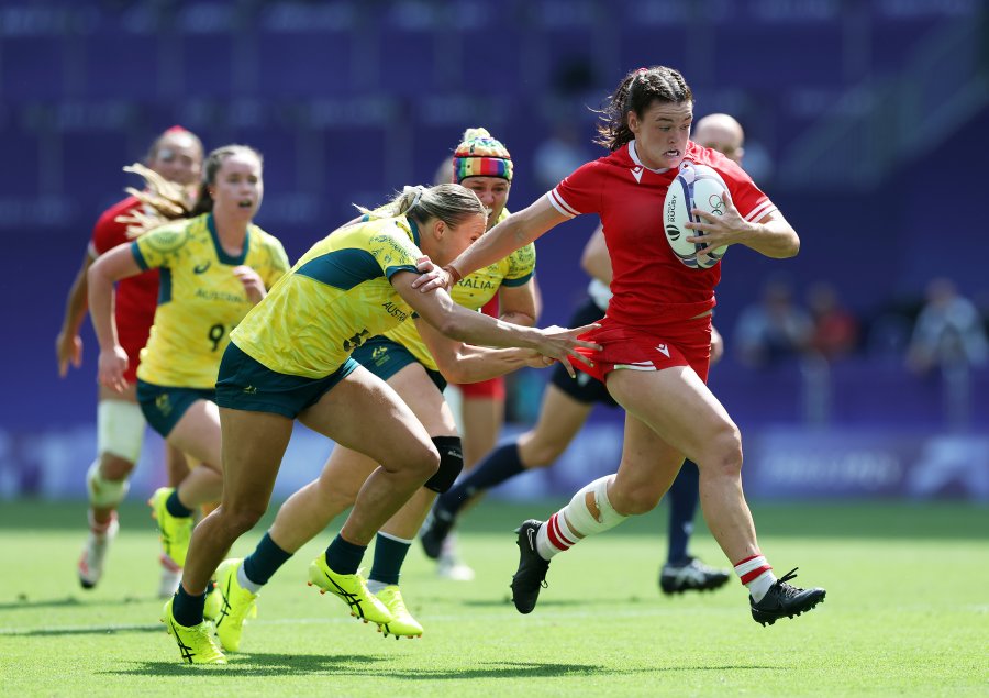 Alysha Corrigan of Team Canada is tackled by Teagan Levi of Team Australia