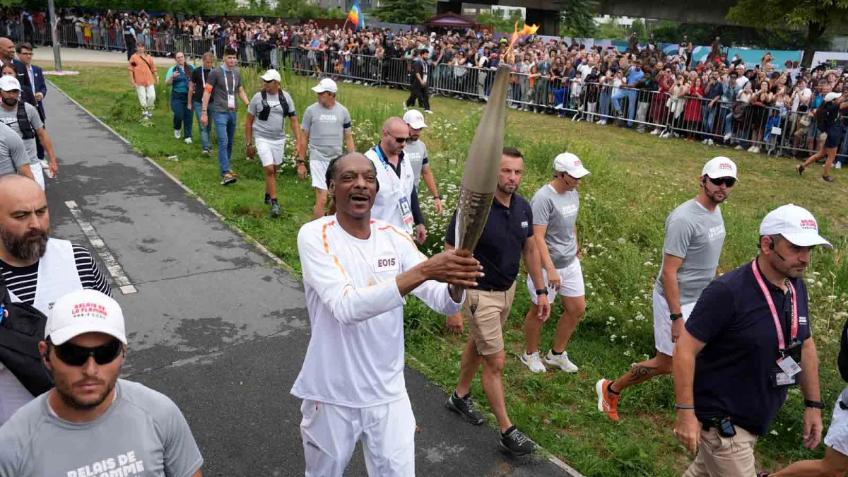 Snoop Dogg carries Olympic torch before Opening Ceremony in Paris NBC