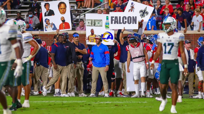 Ole Miss Rebels coaches and players send in offensive plays using posters