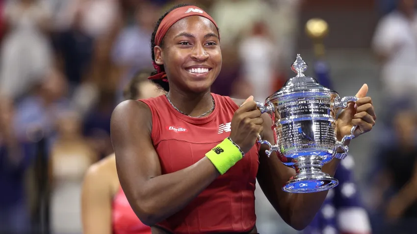 Coco Gauff holding a trophy after winning U.S. Open.