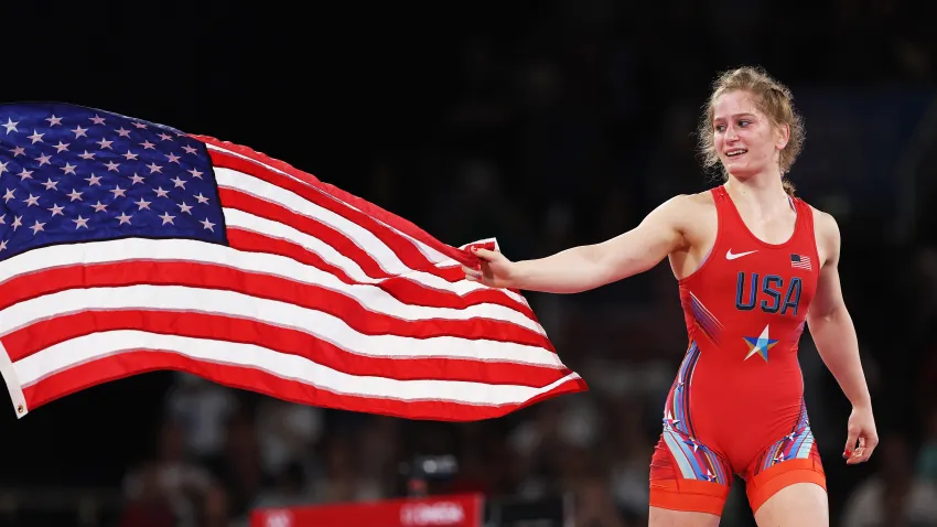 Amit Elor of Team United States celebrates with the United States flag following victory against Meerim Zhumanazarova of Team Kyrgyzstan (not pictured) during the Wrestling Women's Freestyle 68kg Gold Medal match on day eleven of the Olympic Games Paris 2024 at Champs-de-Mars Arena on August 06, 2024 in Paris, France.