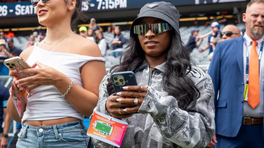 CHICAGO, IL – AUGUST 17: Team USA Olympic Gymnastics Gold Medalist Simone Biles watches the Chicago Bears warm up before a preseason game between the Cincinnati Bengals and the Chicago Bears on August 17, 2024, at Soldier Field in Chicago, Illinois.  (Photo by Joseph Weiser/Icon Sportswire via Getty Images)