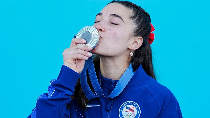 Silver medalist Brooke Raboutou kisses her medal