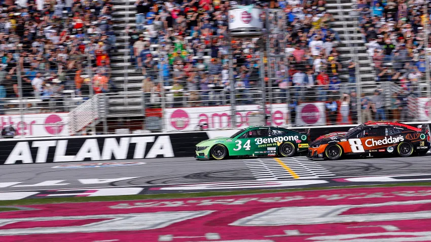 Michael McDowell, driver of the No. 34 Benebone Ford, leads Kyle Busch, driver of the No. 8 Cheddar's Scratch Kitchen Chevrolet