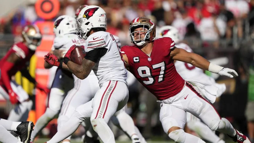 SANTA CLARA, CALIFORNIA – OCTOBER 06: James Conner #6 of the Arizona Cardinals carries the ball as Nick Bosa #97 of the San Francisco 49ers looks to make a tackle at Levi’s Stadium on October 06, 2024 in Santa Clara, California. (Photo by Thearon W. Henderson/Getty Images)