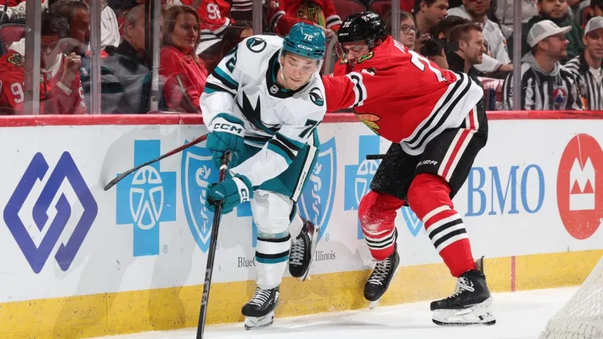 CHICAGO, ILLINOIS – OCTOBER 17: William Eklund #72 of the San Jose Sharks reaches for the puck ahead of Alex Vlasic #72 of the Chicago Blackhawks in the third period at the United Center on October 17, 2024 in Chicago, Illinois. (Photo by Chase Agnello-Dean/NHLI via Getty Images)