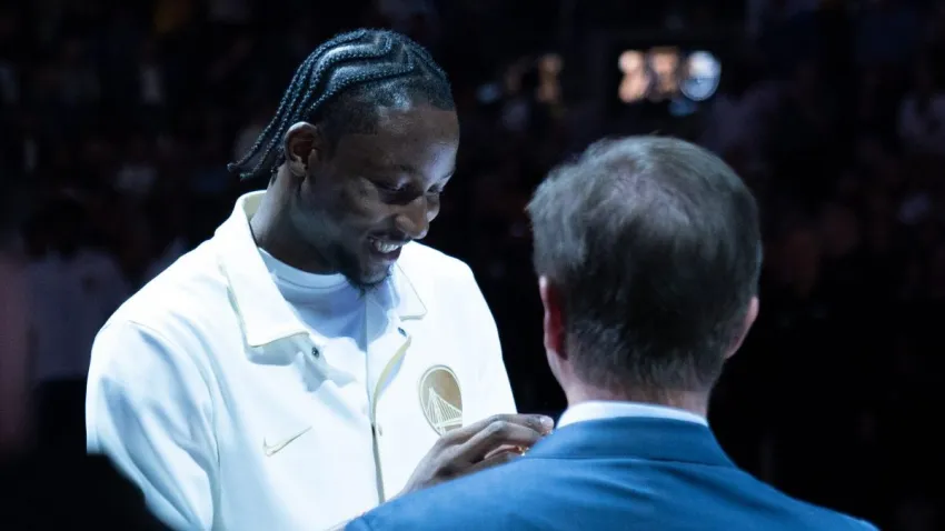 October 18, 2022; San Francisco, California, USA; Golden State Warriors forward Jonathan Kuminga (00) receives his championship ring from owner Joe Lacob (right) before the game against the Los Angeles Lakers at Chase Center. Mandatory Credit: Kyle Terada-USA TODAY Sports