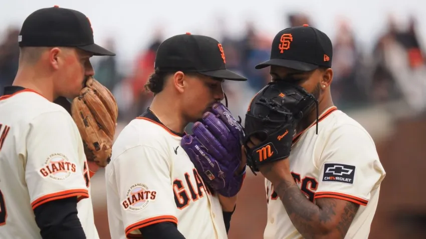 Apr 24, 2025; San Francisco, California, USA; San Francisco Giants third baseman Matt Chapman (26), shortstop Willy Adanes (2) and relief pitcher Camilo Doval (75) cover their mouths with their gloves as they talk on the mound during the ninth inning against the Milwaukee Brewers at Oracle Park. Mandatory Credit: Kelley L Cox-Imagn Images