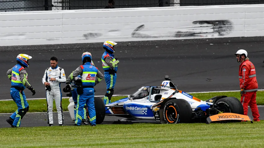 Kyle Larson, second from left, is checked after he hit the wall