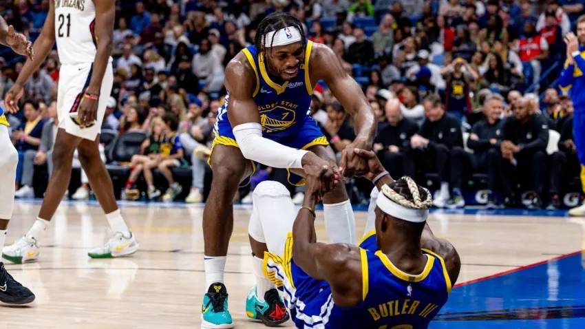 Mar 28, 2025; New Orleans, Louisiana, USA;  Golden State Warriors guard Buddy Hield (7) picks up forward Jimmy Butler III (10) after a play against the New Orleans Pelicans during the second half at Smoothie King Center. Mandatory Credit: Stephen Lew-Imagn Images
