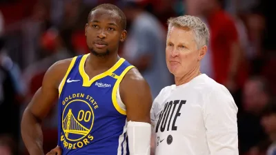 HOUSTON, TEXAS – NOVEMBER 02: Jonathan Kuminga #00 of the Golden State Warriors and head coach Steve Kerr stand on the sideline in overtime against the Houston Rockets at Toyota Center on November 02, 2024 in Houston, Texas.  NOTE TO USER: User expressly acknowledges and agrees that, by downloading and or using this photograph, User is consenting to the terms and conditions of the Getty Images License Agreement.  (Photo by Tim Warner/Getty Images)