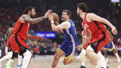 Apr 23, 2025; Houston, Texas, USA; Golden State Warriors guard Pat Spencer (61) drives with the ball as Houston Rockets center Steven Adams (12) defends during game two of the first round for the 2024 NBA Playoffs at Toyota Center. Mandatory Credit: Troy Taormina-Imagn Images