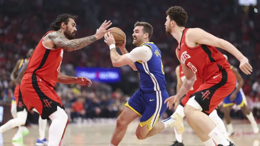 Apr 23, 2025; Houston, Texas, USA; Golden State Warriors guard Pat Spencer (61) drives with the ball as Houston Rockets center Steven Adams (12) defends during game two of the first round for the 2024 NBA Playoffs at Toyota Center. Mandatory Credit: Troy Taormina-Imagn Images
