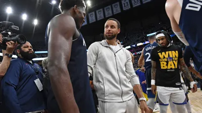 MINNEAPOLIS, MN –  MAY 14: Stephen Curry #30 of the Golden State Warriors hugs Anthony Edwards #5 of the Minnesota Timberwolves after the game during Round 2 Game 5 of the 2025 NBA Playoffs on May 14, 2025 at Target Center in Minneapolis, Minnesota. NOTE TO USER: User expressly acknowledges and agrees that, by downloading and or using this Photograph, user is consenting to the terms and conditions of the Getty Images License Agreement. Mandatory Copyright Notice: Copyright 2025 NBAE (Photo by Noah Graham/NBAE via Getty Images)