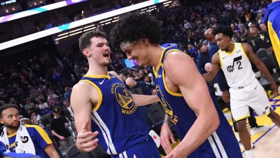 SAN FRANCISCO, CA – JANUARY 28: Quinten Post #21 and Gui Santos #15 of the Golden State Warriors hug after the game against the Utah Jazz on January 27, 2025 at Chase Center in San Francisco, California. NOTE TO USER: User expressly acknowledges and agrees that, by downloading and or using this photograph, user is consenting to the terms and conditions of Getty Images License Agreement. Mandatory Copyright Notice: Copyright 2025 NBAE (Photo by Noah Graham/NBAE via Getty Images)