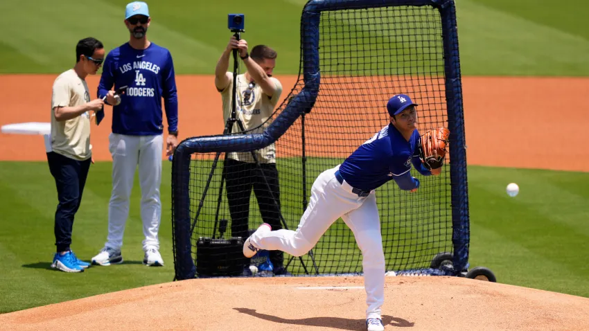 Los Angeles Dodgers’ pitcher Shohei Ohtani, center, throws live batting practice as pitching coach Mark Prior, second from left, watches prior to a baseball game against the New York Yankees, Saturday, May 31, 2025, in Los Angeles. (AP Photo/Mark J. Terrill)