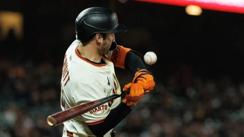 Jun 25, 2025; San Francisco, California, USA; San Francisco Giants first baseman Casey Schmitt (10) is hit by a pitch during the ninth inning against the Miami Marlins at Oracle Park. Mandatory Credit: Sergio Estrada-Imagn Images