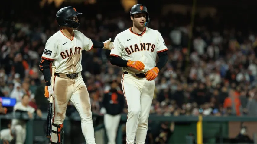 Jun 25, 2025; San Francisco, California, USA; San Francisco Giants first baseman Casey Schmitt (10) walks to first after getting hit by a pitch during the ninth inning against the Miami Marlins at Oracle Park. Mandatory Credit: Sergio Estrada-Imagn Images
