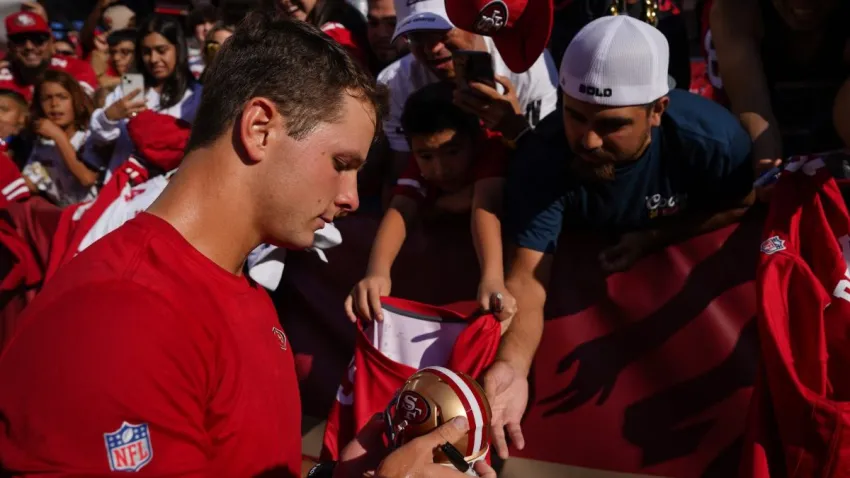 SANTA CLARA, CALIFORNIA – AUGUST 25: Brock Purdy #13 of the San Francisco 49ers signs autographs for fans before playing the Los Angeles Chargers in a preseason game at Levi’s Stadium on August 25, 2023 in Santa Clara, California. (Photo by Loren Elliott/Getty Images)