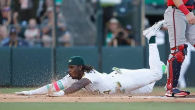 SACRAMENTO, CALIFORNIA – JULY 08: Lawrence Butler #4 of the Athletics slides into home plate to score an inside-the-park home run in the bottom of the first inning against the Atlanta Braves at Sutter Health Park on July 08, 2025 in Sacramento, California. (Photo by Lachlan Cunningham/Getty Images)