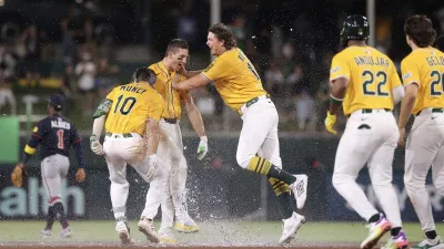 SACRAMENTO, CALIFORNIA – JULY 10: Tyler Soderstrom #21 of the Athletics celebrates with Max Muncy #10 and Nick Kurtz #16 after hitting an RBI single for a walk-off win against the Atlanta Braves during the 11th inning at Sutter Health Park on July 10, 2025 in Sacramento, California. (Photo by Kelley L Cox/Getty Images)