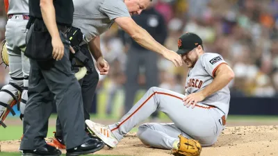 SAN DIEGO, CALIFORNIA – AUGUST 20: Landen Roupp #65 of the San Francisco Giants reacts after being hit by a line drive from Ramón Laureano #5 of the San Diego Padres during the third inning of a game at Petco Park on August 20, 2025 in San Diego, California. (Photo by Sean M. Haffey/Getty Images)