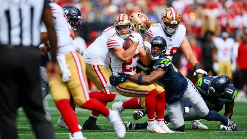 Sep 7, 2025; Seattle, Washington, USA; Seattle Seahawks safety Nick Emmanwori (3) tackles San Francisco 49ers running back Christian McCaffrey (23) during the first half at Lumen Field. Mandatory Credit: Steven Bisig-Imagn Images