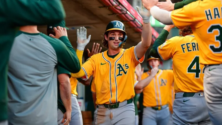 Sep 6, 2025; Anaheim, California, USA; Athletics shortstop Jacob Wilson (5) is greeted after scoring a run against the Los Angeles Angels. during the first inning at Angel Stadium. Mandatory Credit: Gary A. Vasquez-Imagn Images