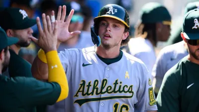 Sep 7, 2025; Anaheim, California, USA; Athletics first baseman Nick Kurtz (16) is greeted by teammates after scoring to tie the game against the Los Angeles Angels during the eighth inning at Angel Stadium. Mandatory Credit: William Liang-Imagn Images