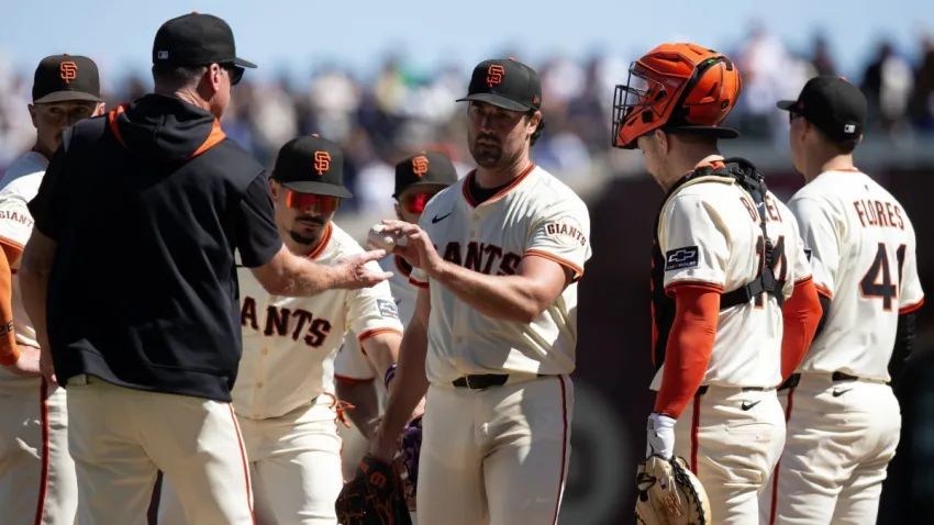 Sep 14, 2025; San Francisco, California, USA; San Francisco Giants starting pitcher Robbie Ray (center) hands the ball off to manager Bob Melvin as he is removed for a reliever during the fifth inning against the Los Angeles Dodgers at Oracle Park. Mandatory Credit: D. Ross Cameron-Imagn Images