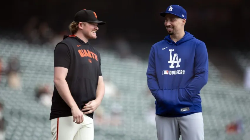Sep 14, 2025; San Francisco, California, USA; Former teammates, San Francisco Giants pitcher Logan Webb (left) and Los Angeles Dodgers pitcher Blake Snell chat before the teams meet at Oracle Park. Mandatory Credit: D. Ross Cameron-Imagn Images