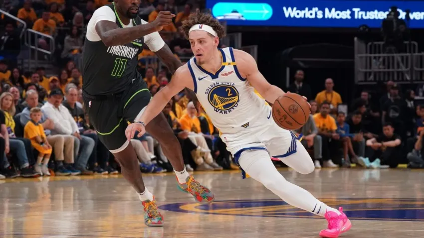 May 10, 2025; San Francisco, California, USA; Golden State Warriors guard Brandin Podziemski (2) dribbles past Minnesota Timberwolves center-forward Naz Reid (11) in the second quarter during game three in the second round of the 2025 NBA Playoffs at Chase Center. Mandatory Credit: David Gonzales-Imagn Images