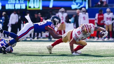 Nov 2, 2025; East Rutherford, New Jersey, USA; San Francisco 49ers tight end George Kittle (85) is tackled by. New York Giants linebacker Bobby Okereke (58) during the first half at MetLife Stadium. Mandatory Credit: Ed Mulholland-Imagn Images