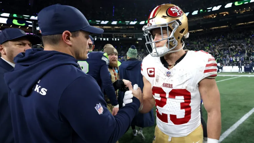 SEATTLE, WASHINGTON – JANUARY 17: Head coach Mike MacDonald of the Seattle Seahawks shakes hands with Christian McCaffrey #23 of the San Francisco 49ers after the NFC Divisional Playoff game at Lumen Field on January 17, 2026 in Seattle, Washington.  (Photo by Harry How/Getty Images)